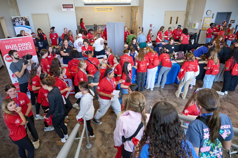 Group of girls coming down the stairs into the educational area.